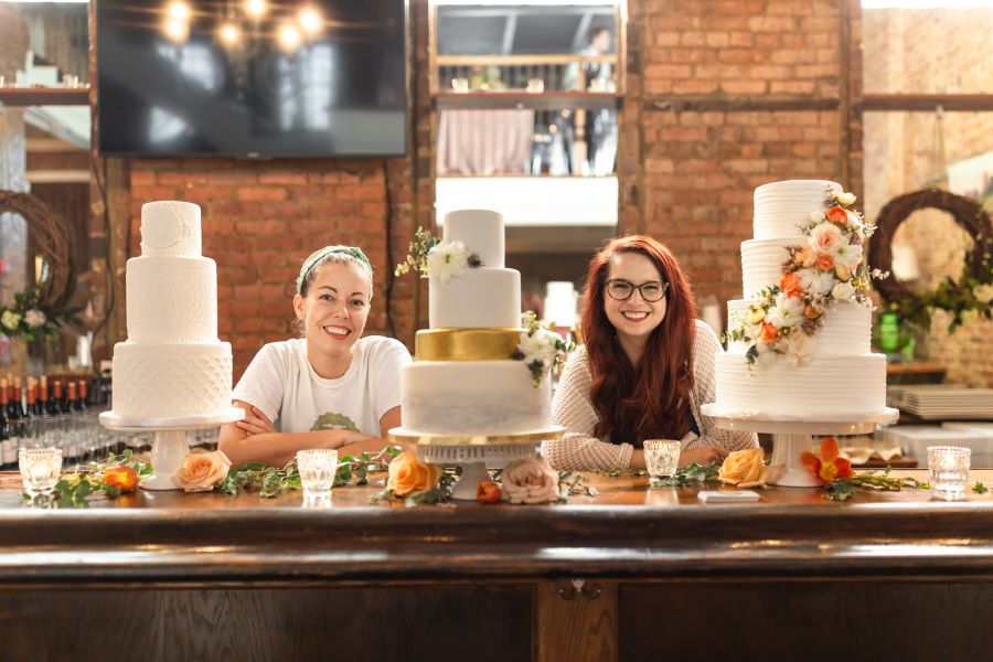Baked in Nashville bakers standing by their wedding cakes on display / Whimsical / Summer / August / Yellow / Lavender / Blush