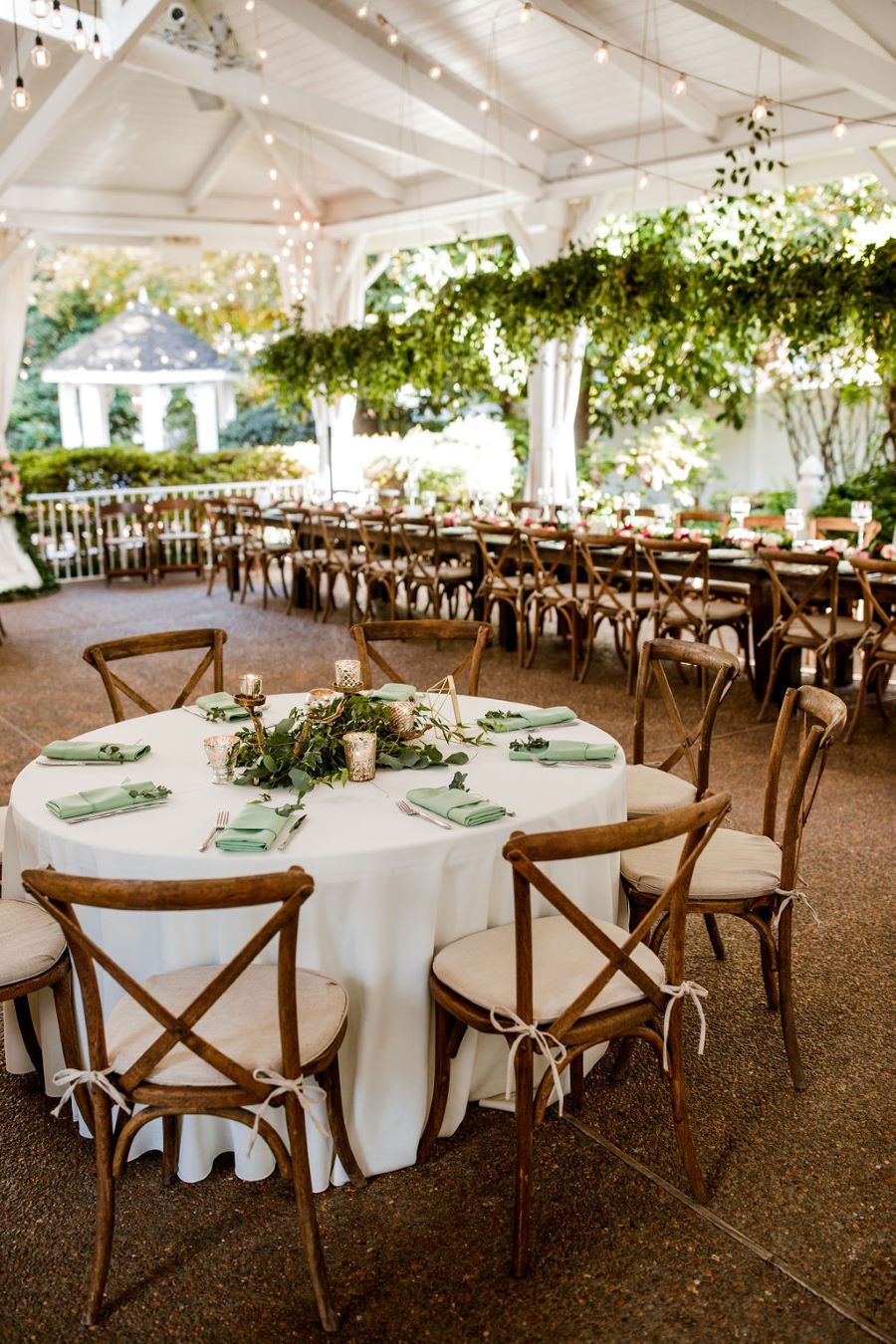 Mixed tables set up in outdoor reception space for fall wedding / Romantic / Moody / Fall / Sage Green / Berry / Beige